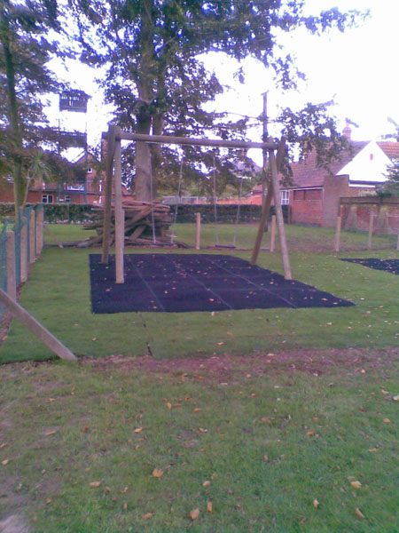 Completion of playground surface and lawn